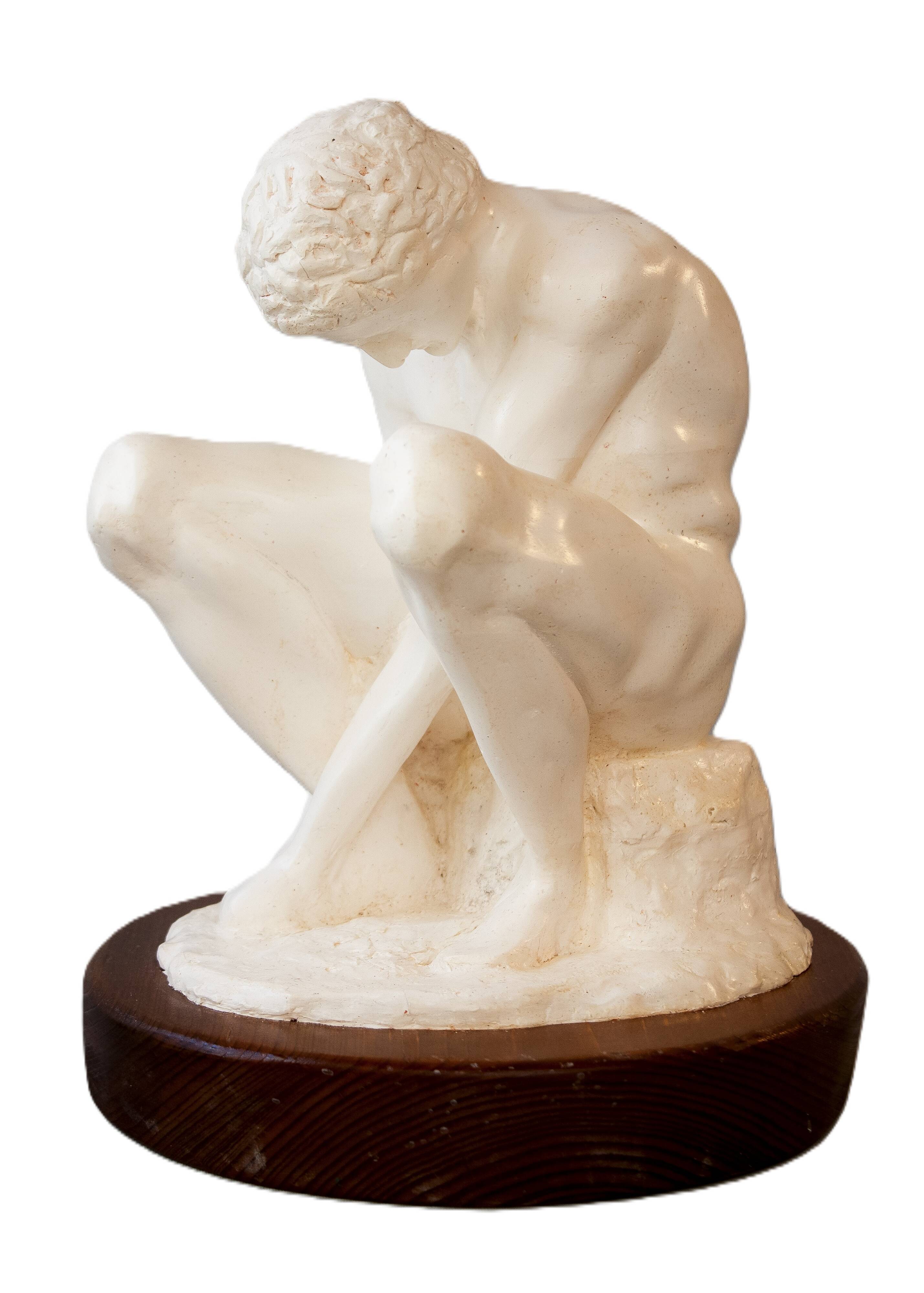 Sculpture of a seated man. Classical male sculpture. Male figure.