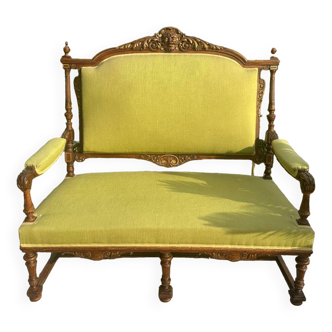 Richly carved solid wood bench in Louis XVI style.