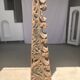 Indonesian construction element in carved wood with intertwined plant motifs mounted on a base (fri