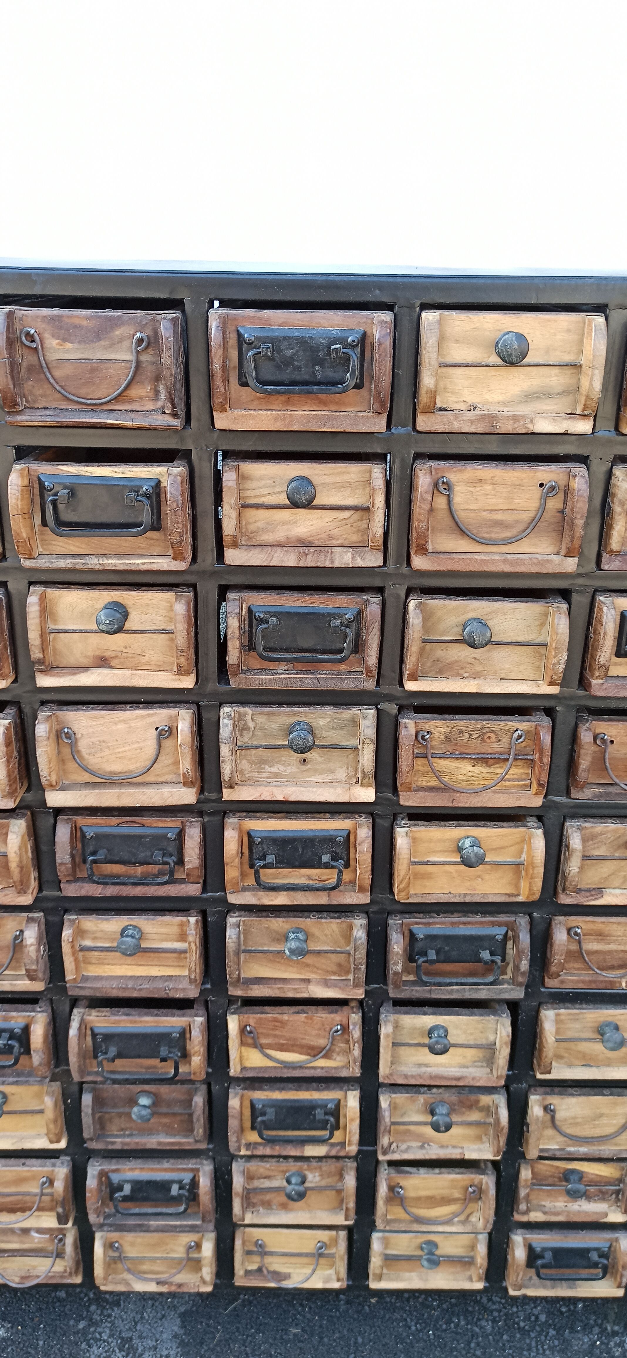 Black metal storage cabinet with 60 wooden drawers