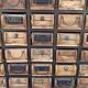 Black metal storage cabinet with 60 wooden drawers