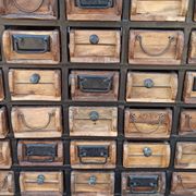 Black metal storage cabinet with 60 wooden drawers
