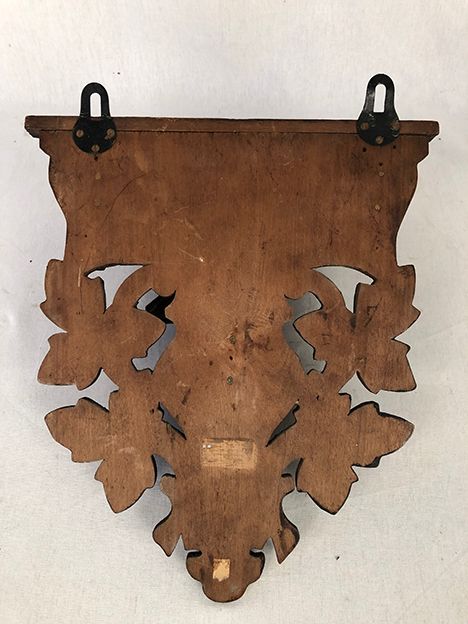 Pair of carved wooden wall consoles decorated with a deer's head