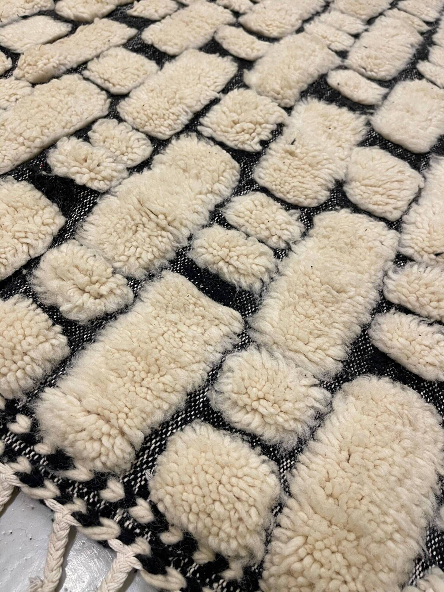Large cream and black checked Berber rug, 280 × 200 cm.