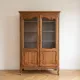 Antique display cabinet in Louis XV style made of wood.