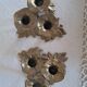 Pair of antique three-branch candlesticks with a floral design.