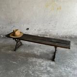 Dark brown wood and black cast-iron antique garden bench with weathered solid-wood seat