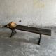 Dark brown wood and black cast-iron antique garden bench with weathered solid-wood seat