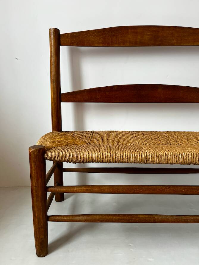 Old wooden and straw bench