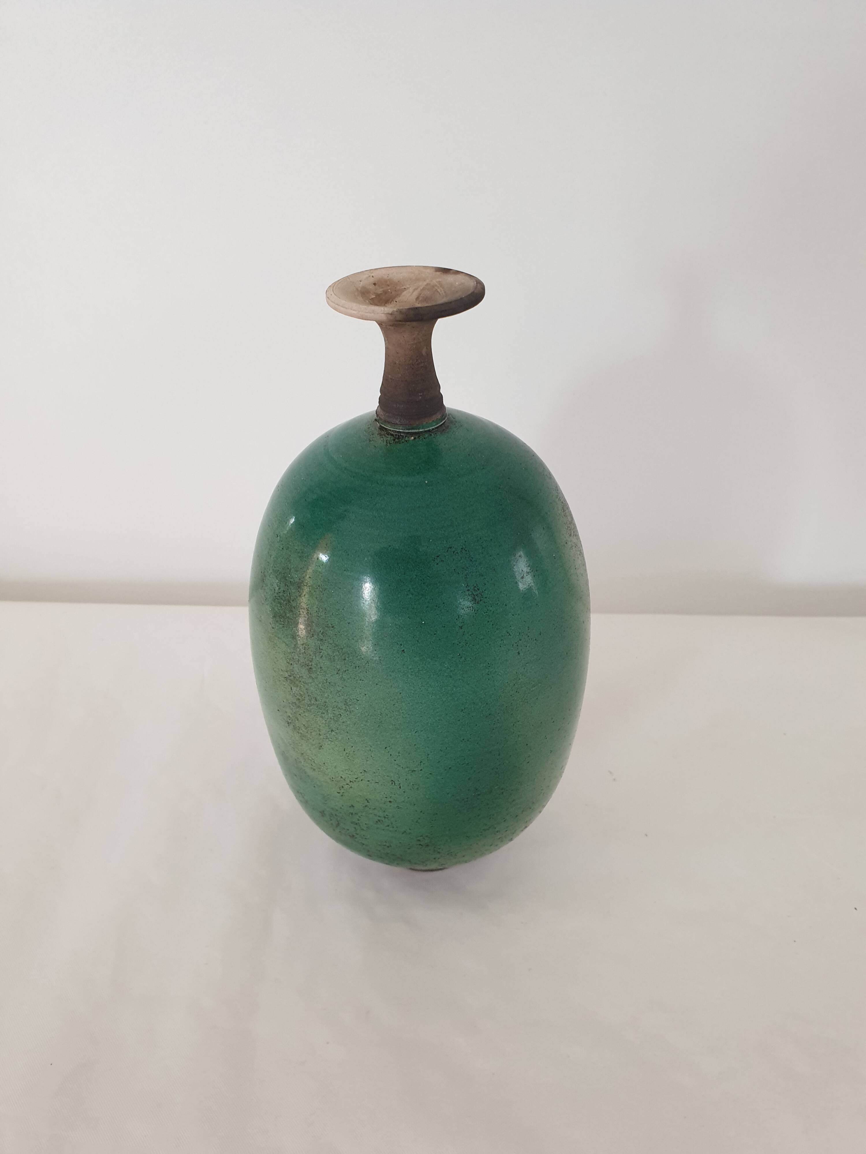 Green pot-bellied ceramic vase with foot and high, narrow neck in signed raku