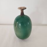 Green pot-bellied ceramic vase with foot and high, narrow neck in signed raku