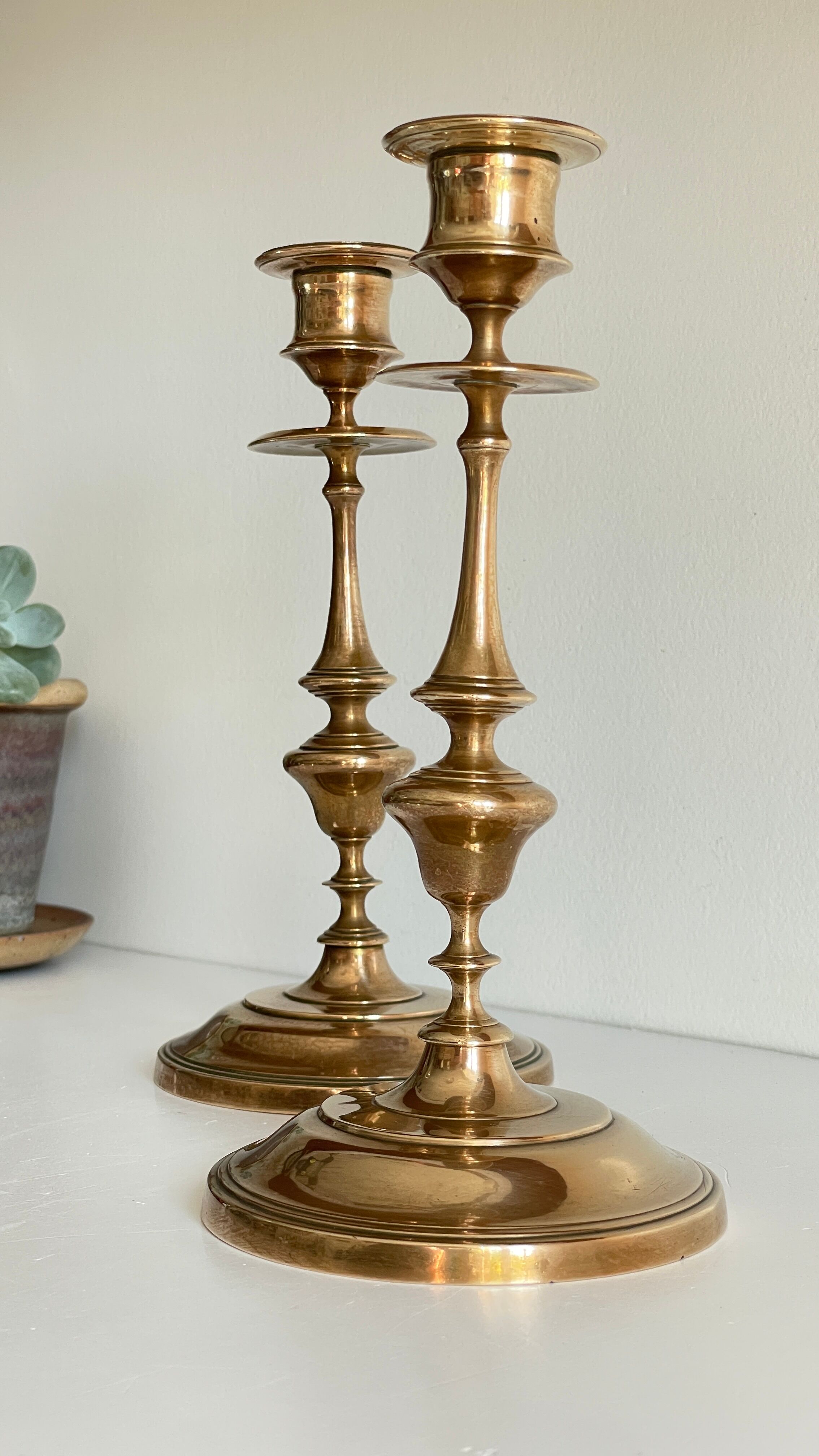 Pair of antique candle holders in solid brass