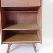 Vintage 1960s secretary desk with an angled design, light wood, and tapered legs.