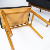 Easy chair with stool in teak and dark wool fabric of danish design from the 1960s.