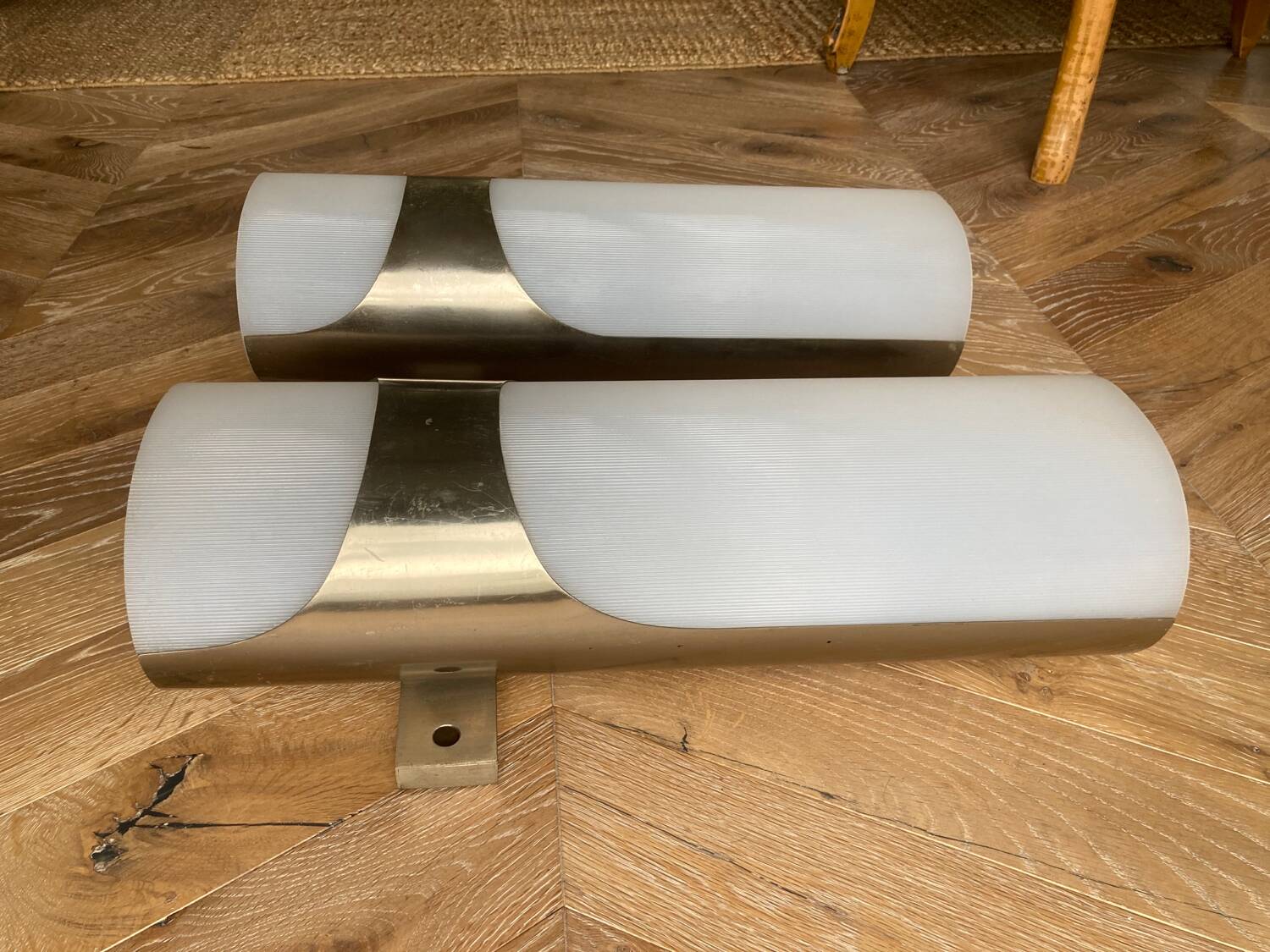 Brushed metal and ribbed opal plastic wall lights