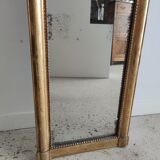 Long wooden mirror and gilded stucco with pearl rays H: 2m45 L: 40cm