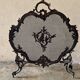 Spark screen, fire screen, bronze fireplace screen decorated with a covered cherub