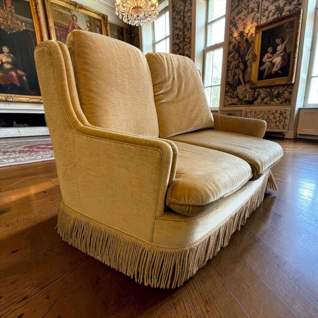 Vintage beige two-seater sofa with fringes