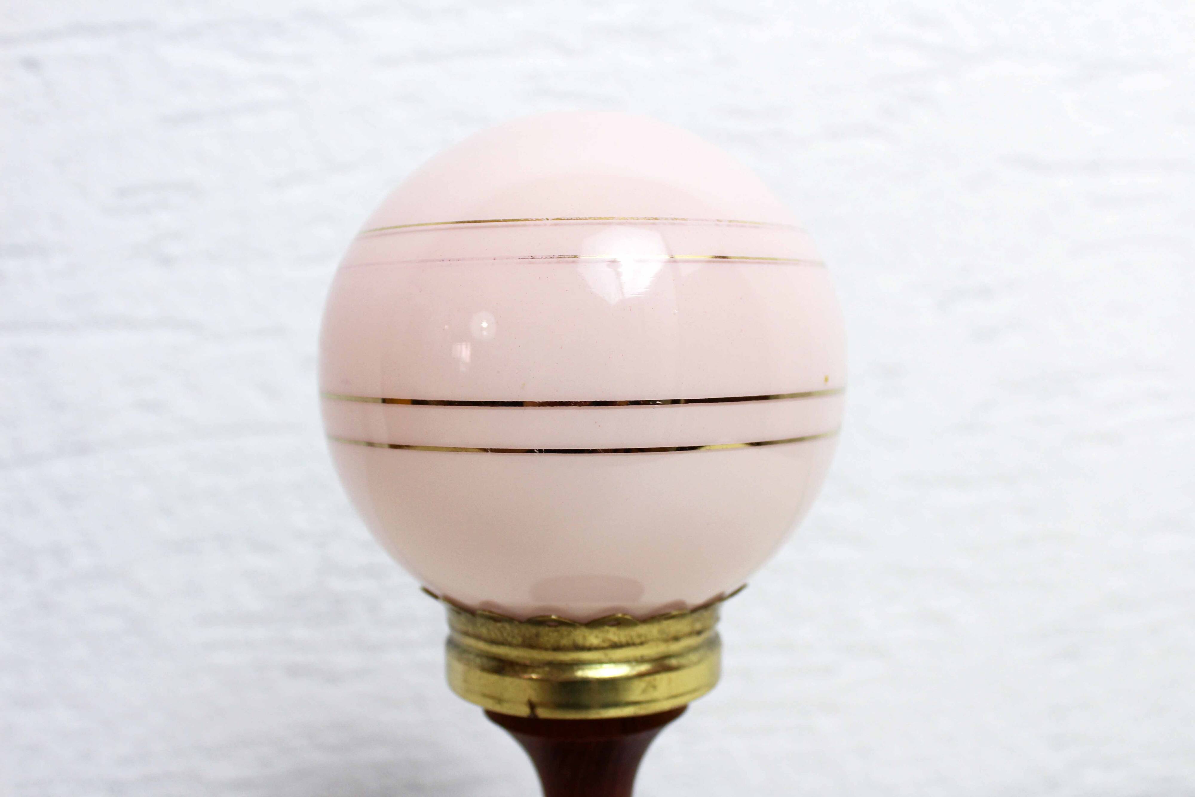 Turned wood and pink glass lamp