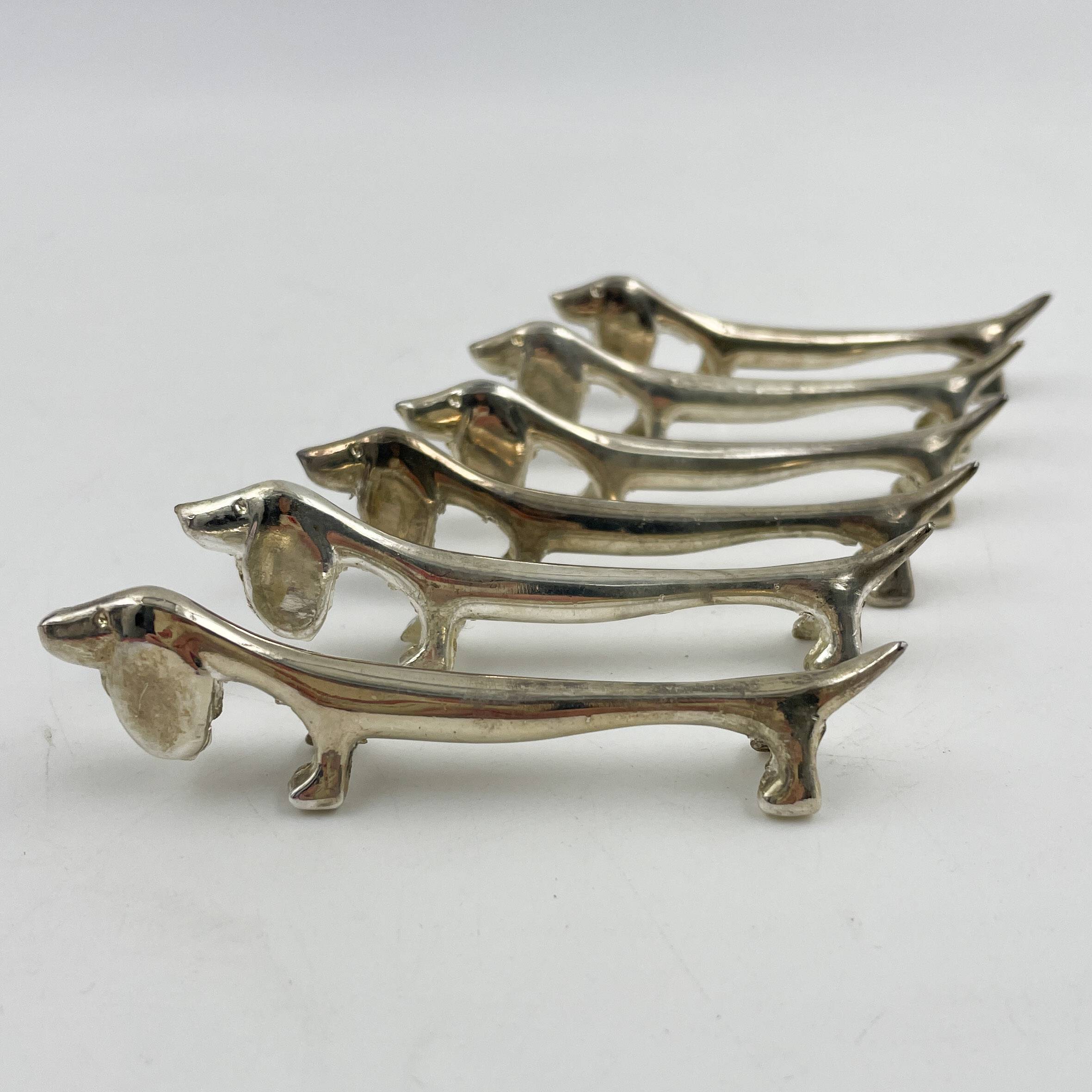 Set of 6 silver metal Dachshund knife holders, 1970s