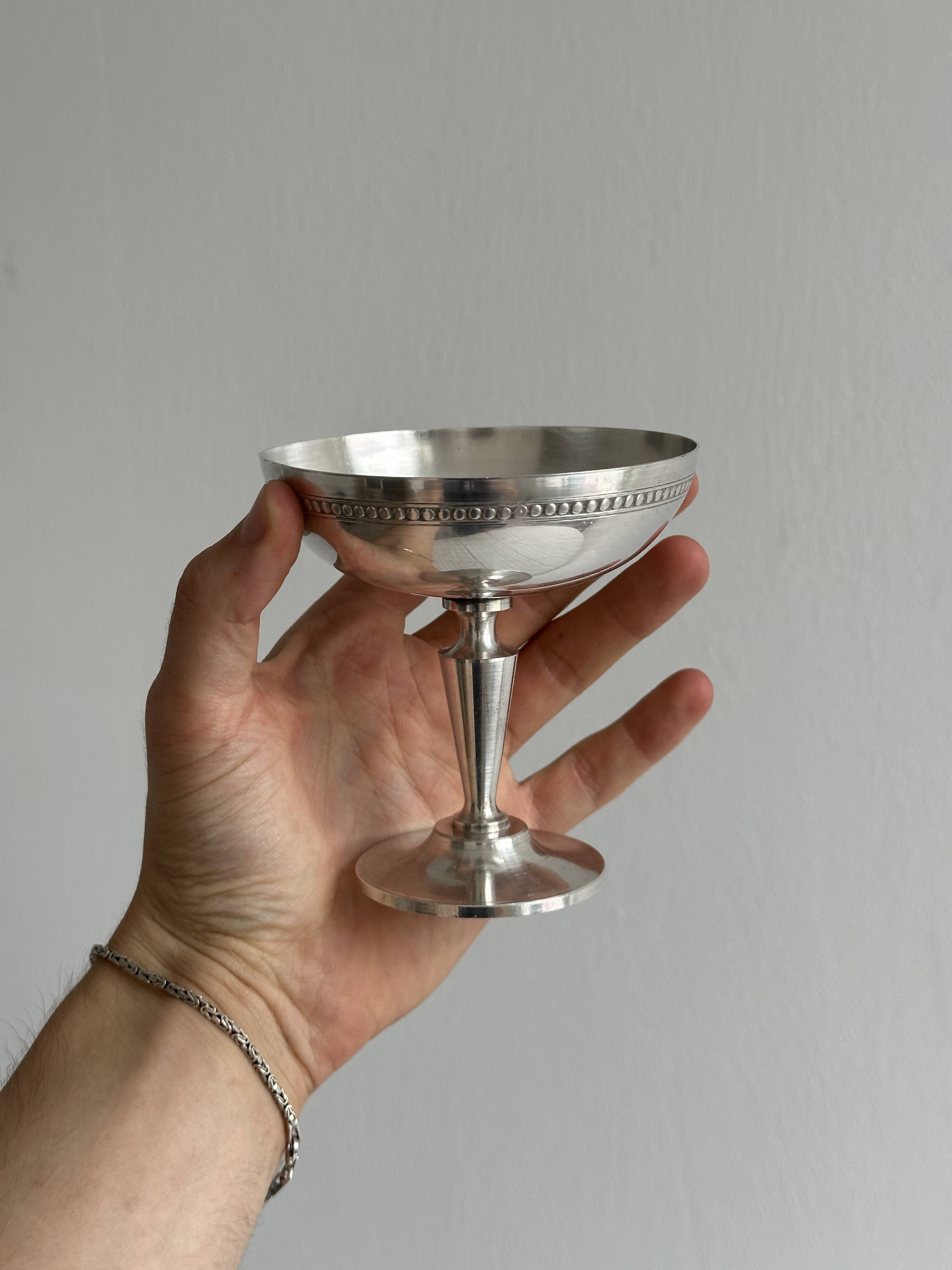 Silver-plated metal bowl on a stand