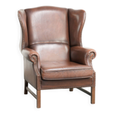 Comfortable cowhide wingback armchair in English style with a timeless look