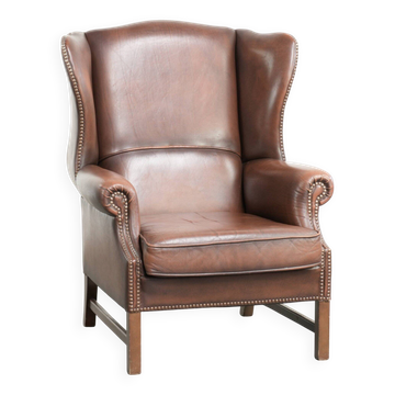Comfortable cowhide wingback armchair in English style with a timeless look