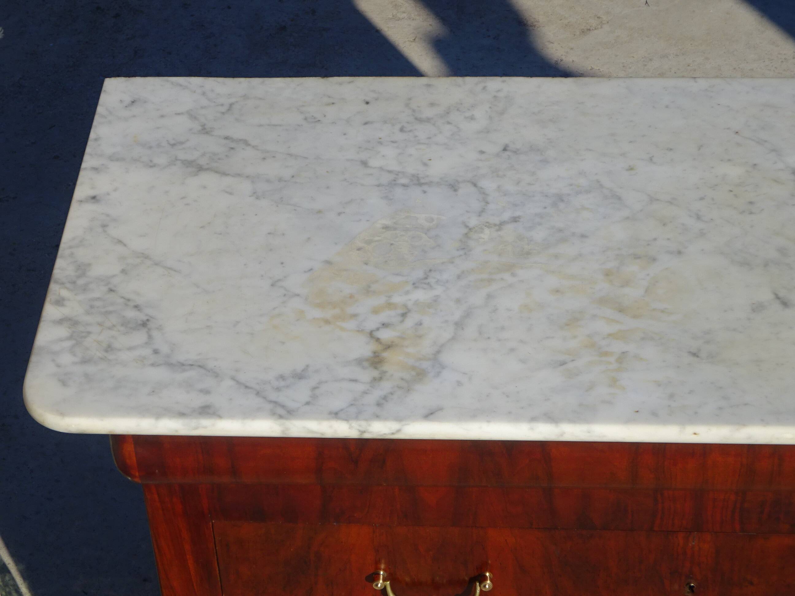 Antique mahogany chest of drawers with white marble.