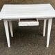 Vintage white wooden kitchen table with drawer from the 19th century.