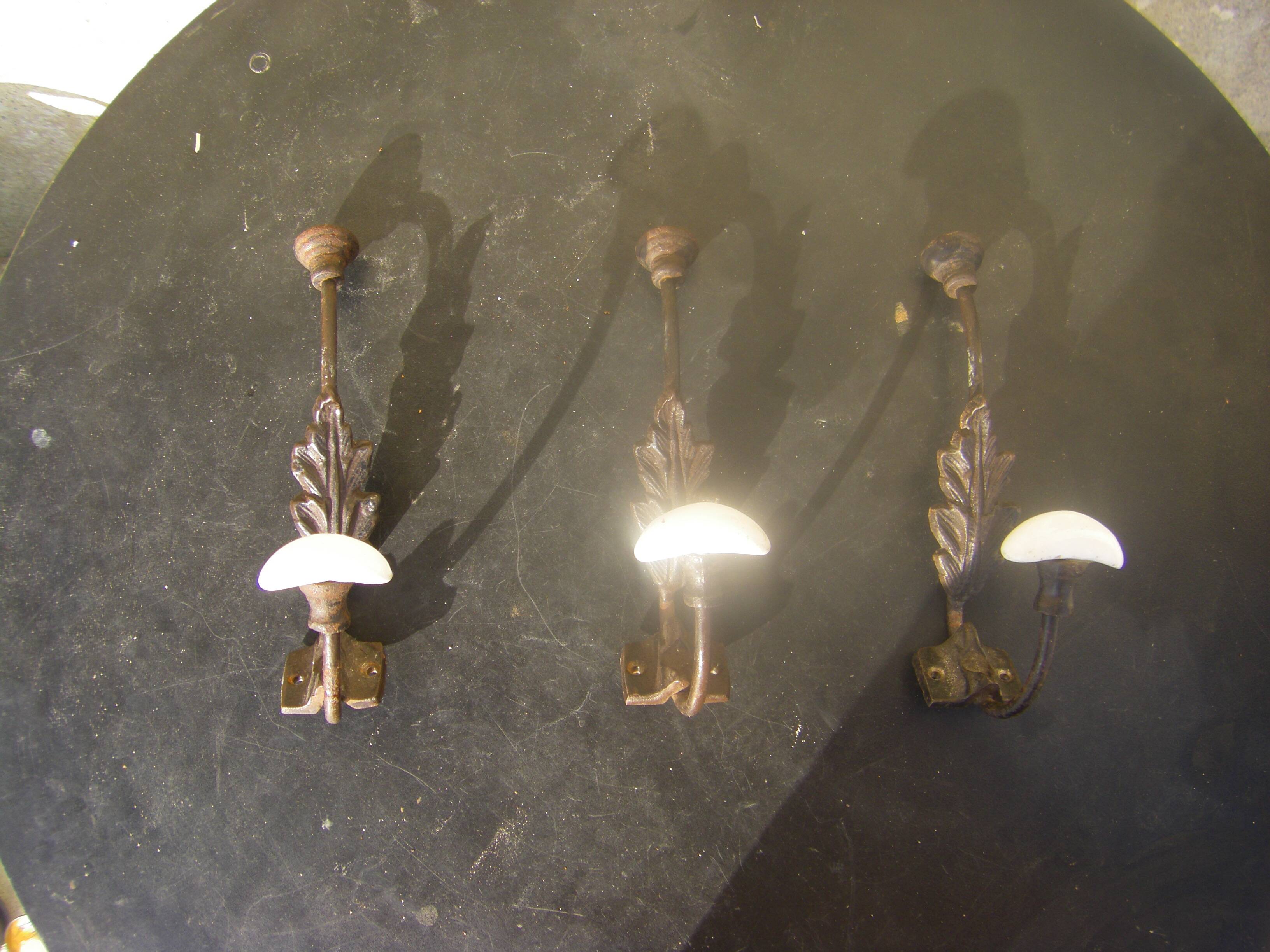 Trio of vintage coat hooks.