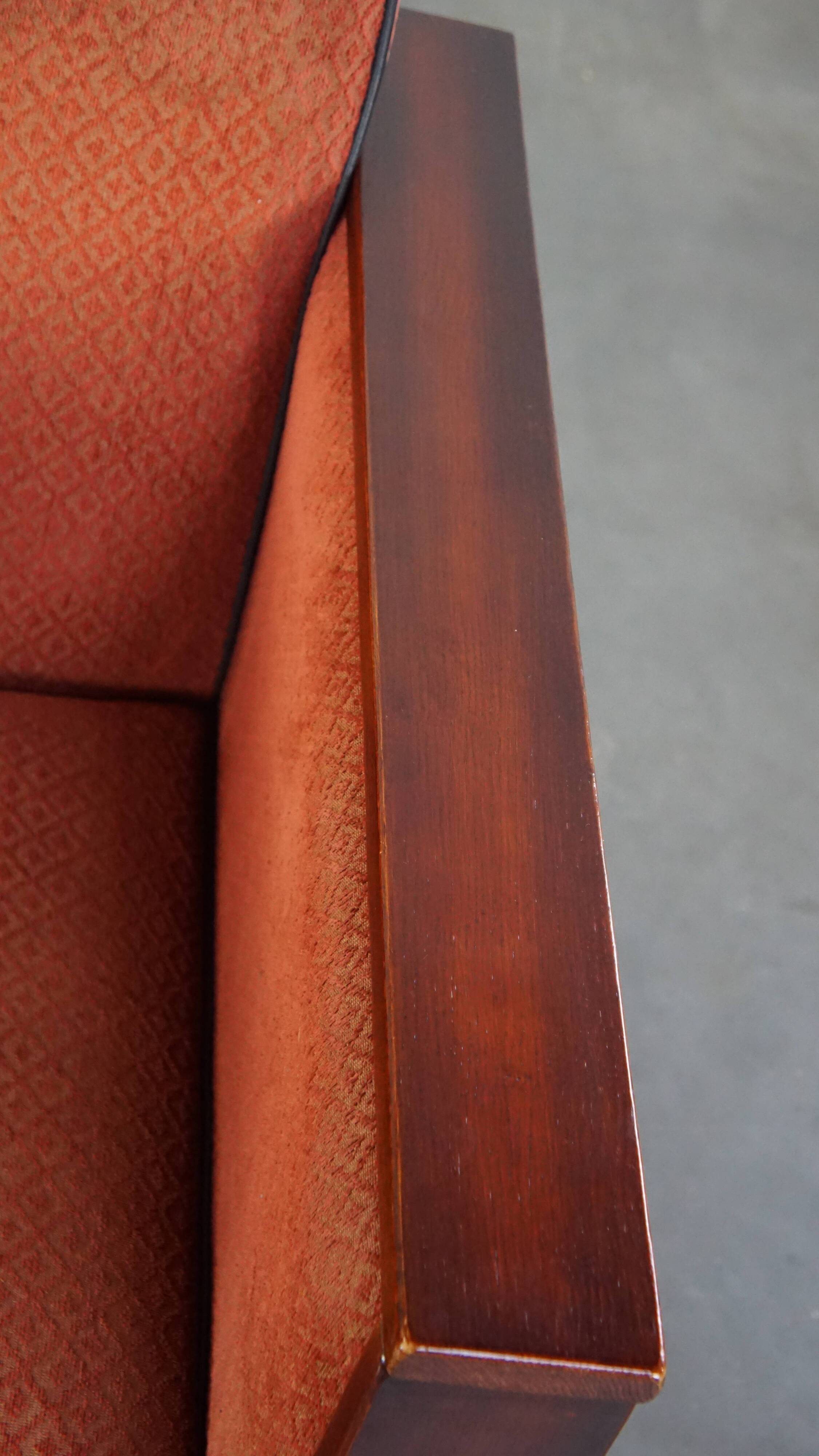 Art Deco design armchair with red fabric upholstery and wooden details