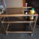 Brass and smoked glass bar trolley with casters