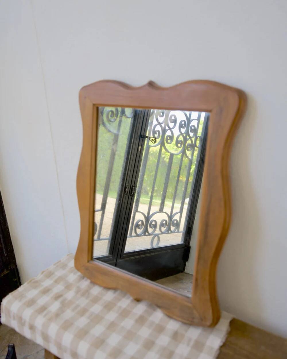 Wooden mirror with a shaped frame