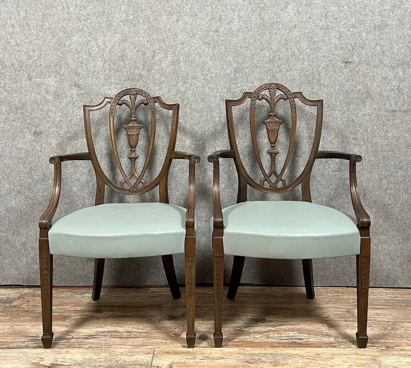 According to George Hepplewhite: pair of 19th century mahogany office armchairs