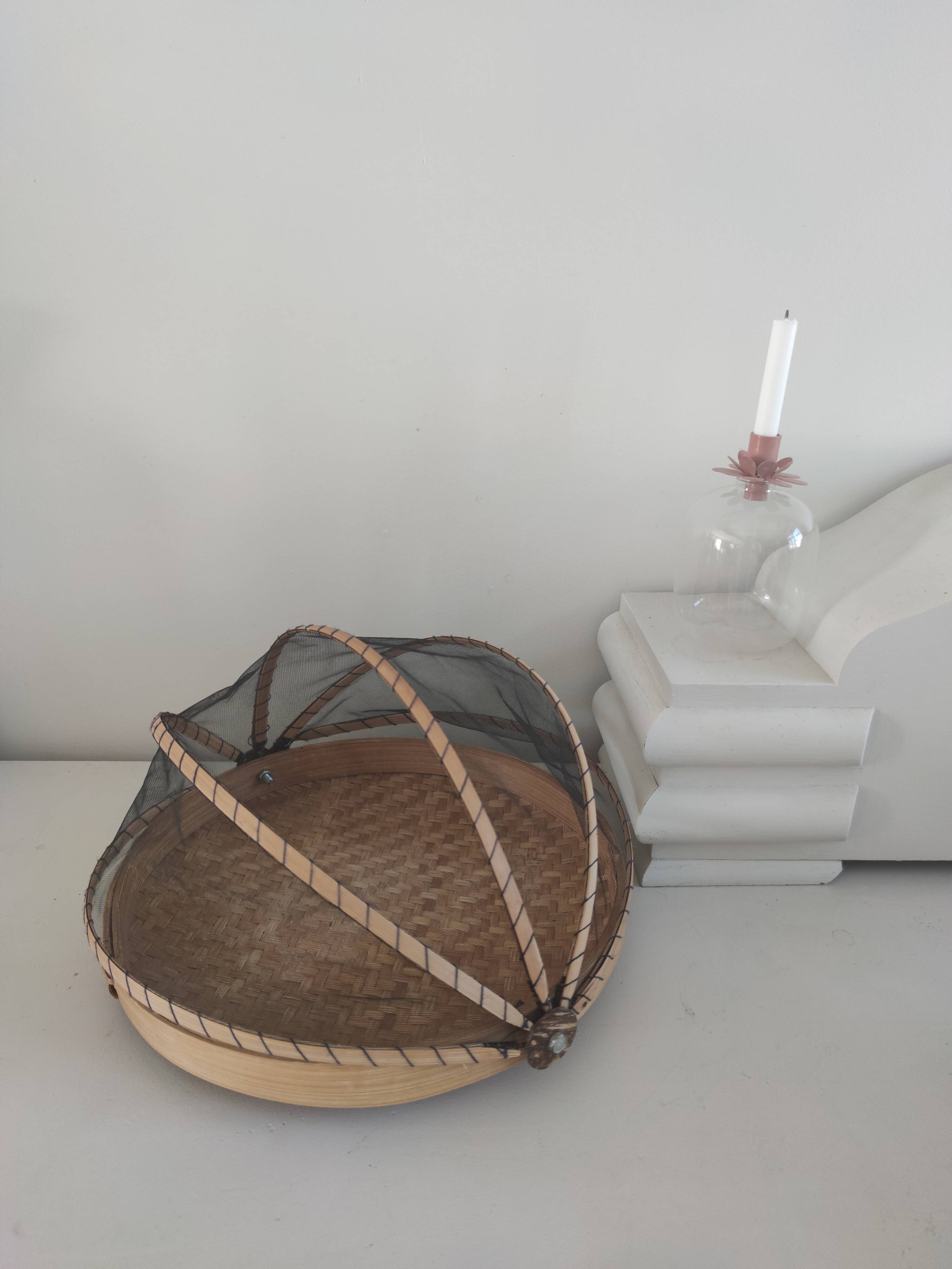 Braided basket with protective mosquito net