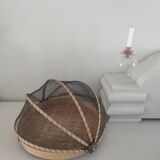 Braided basket with protective mosquito net