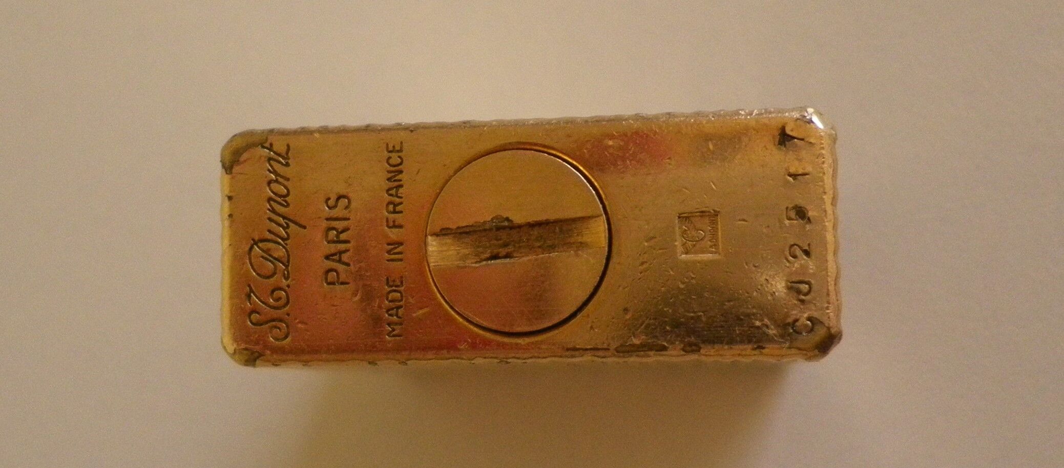 2 st dupont lighters, gold plated, punches, numbered, 1 striated pattern, 1 hammered pattern, 70s