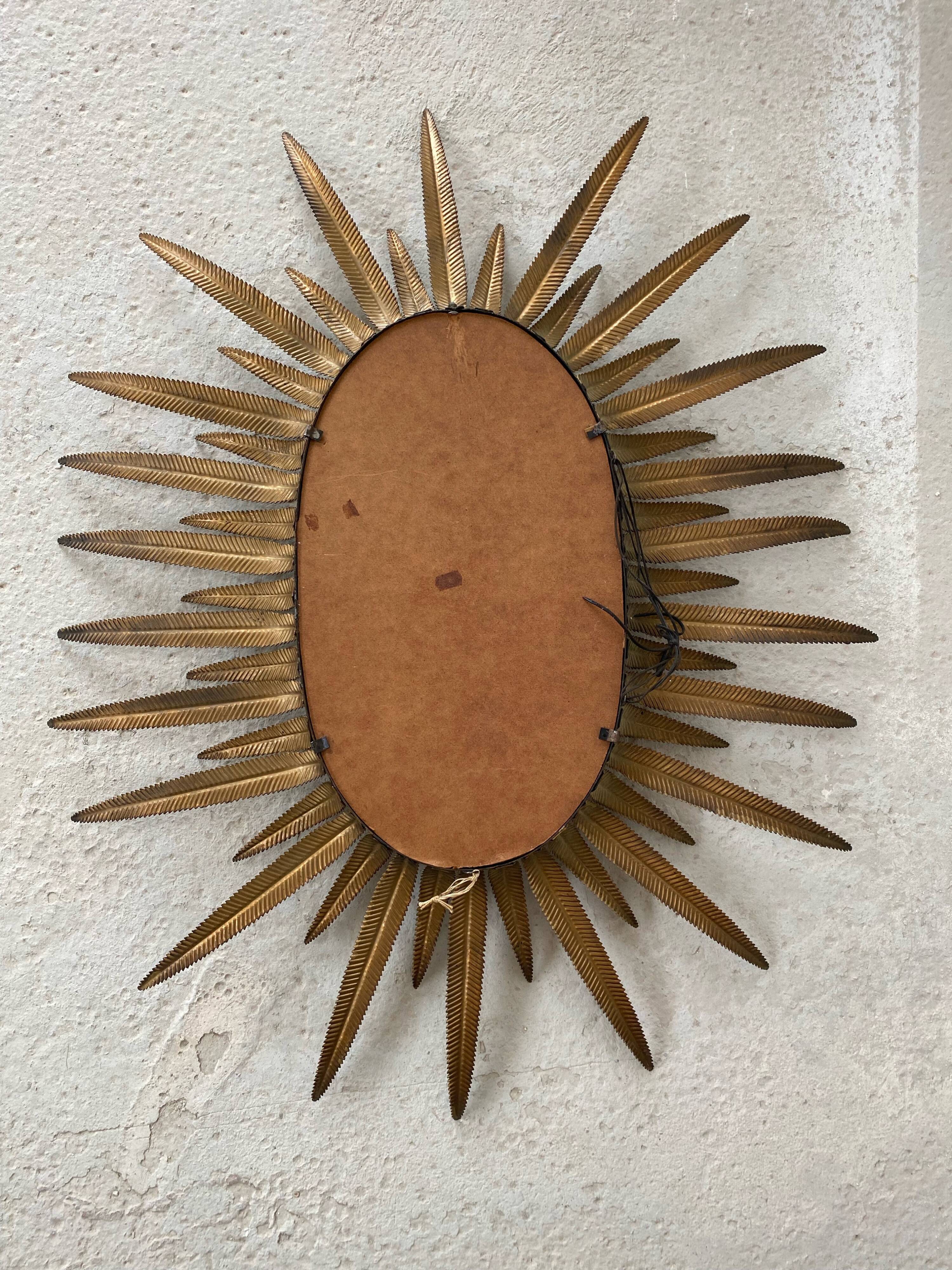 Vintage copper metal sun mirror oval shaped from the 1960s