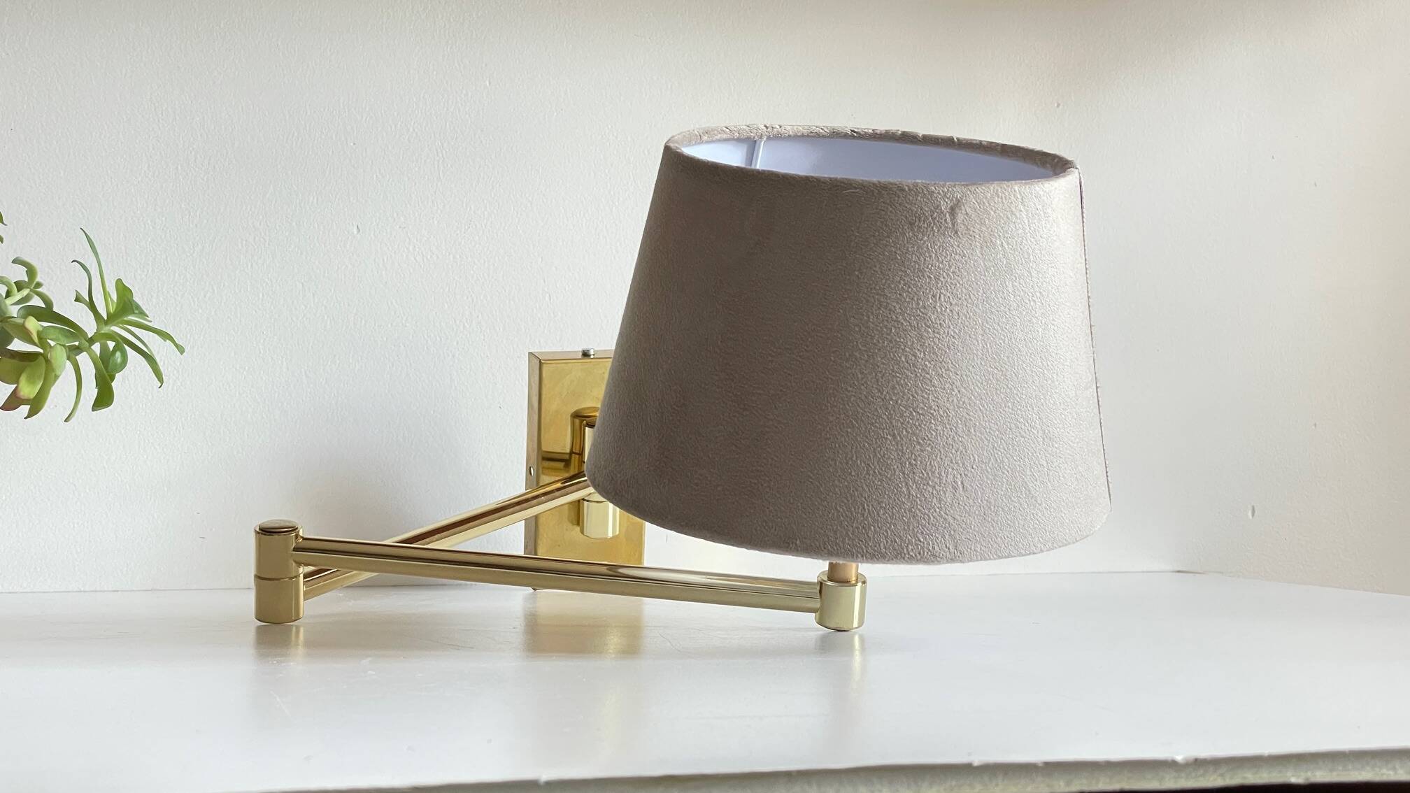 articulated brass and velvet wall light
