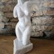 Sculpture of a female torso in white marble.