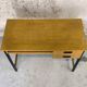 Vintage desk in modernist style made of wood.