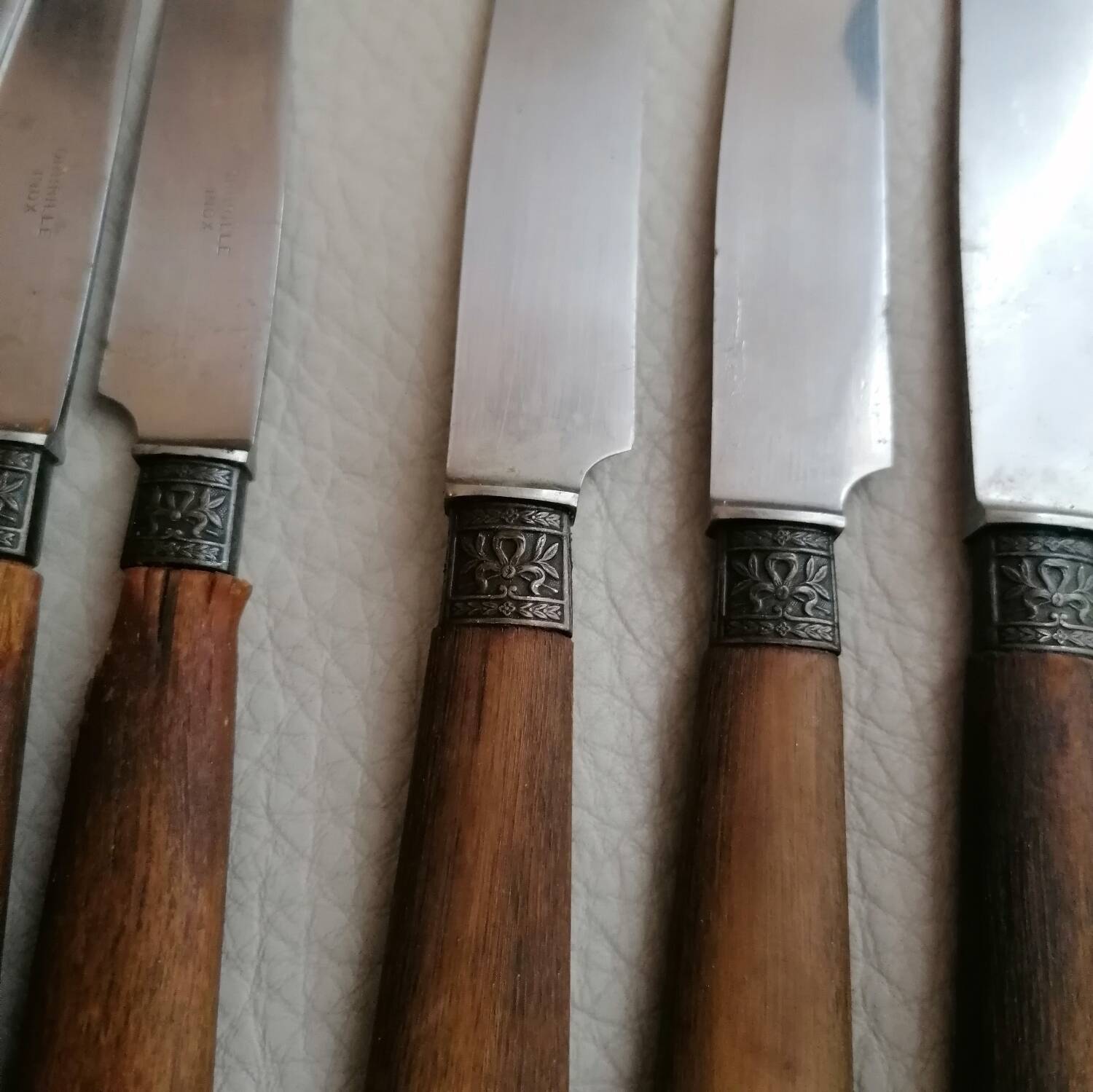 Old table knives and dessert knives, wooden handles, stainless steel blades