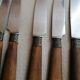 Old table knives and dessert knives, wooden handles, stainless steel blades
