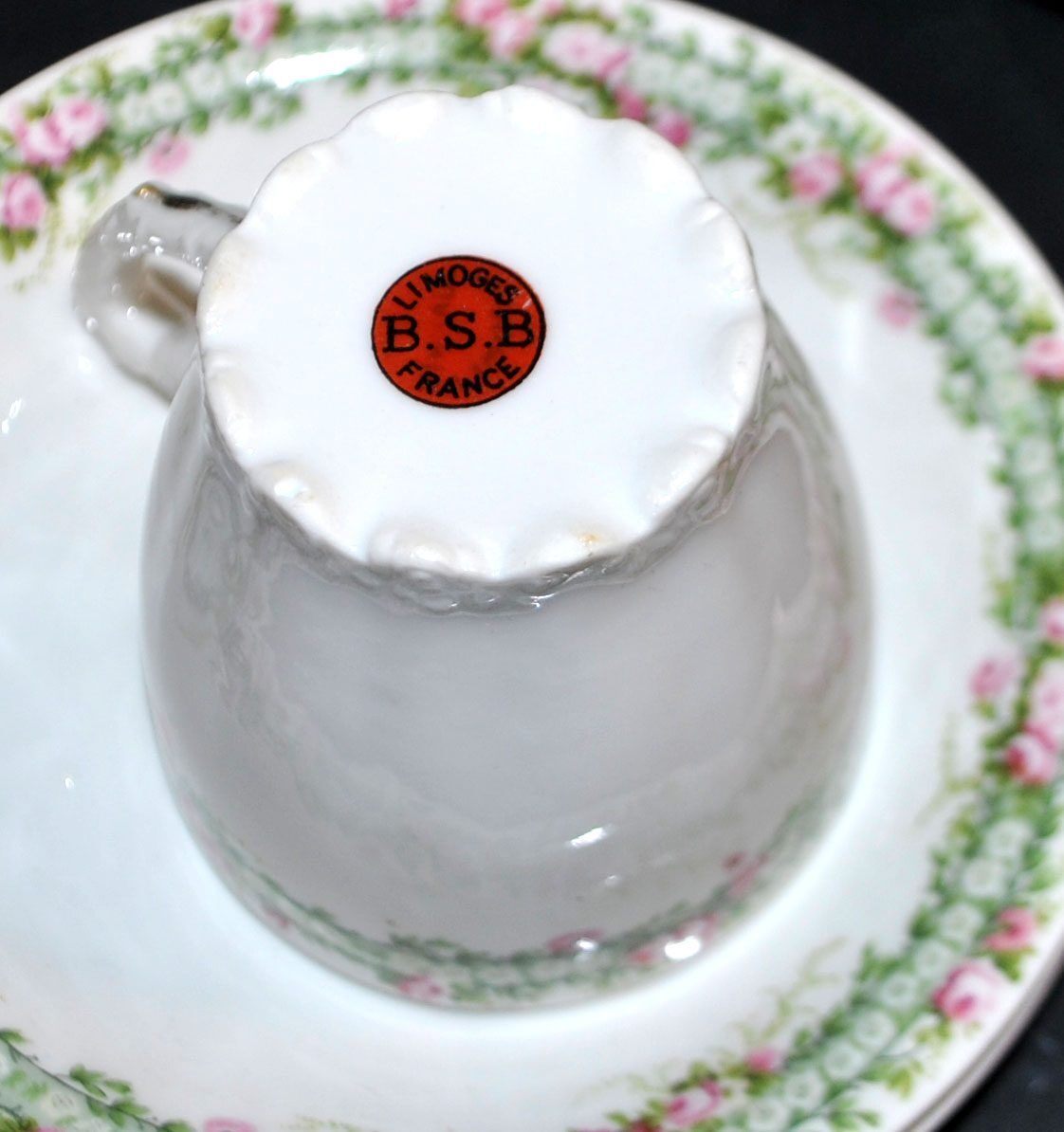 Vintage Limoges coffee service with pink and green floral decoration, coffee pot, sugar bowl, and 6 cups.