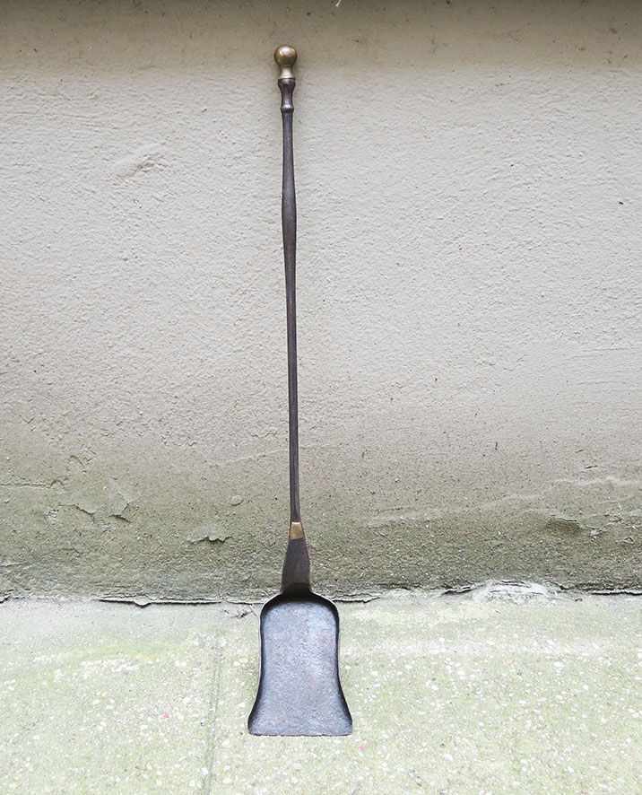 Old chimney shovel in wrought iron and brass