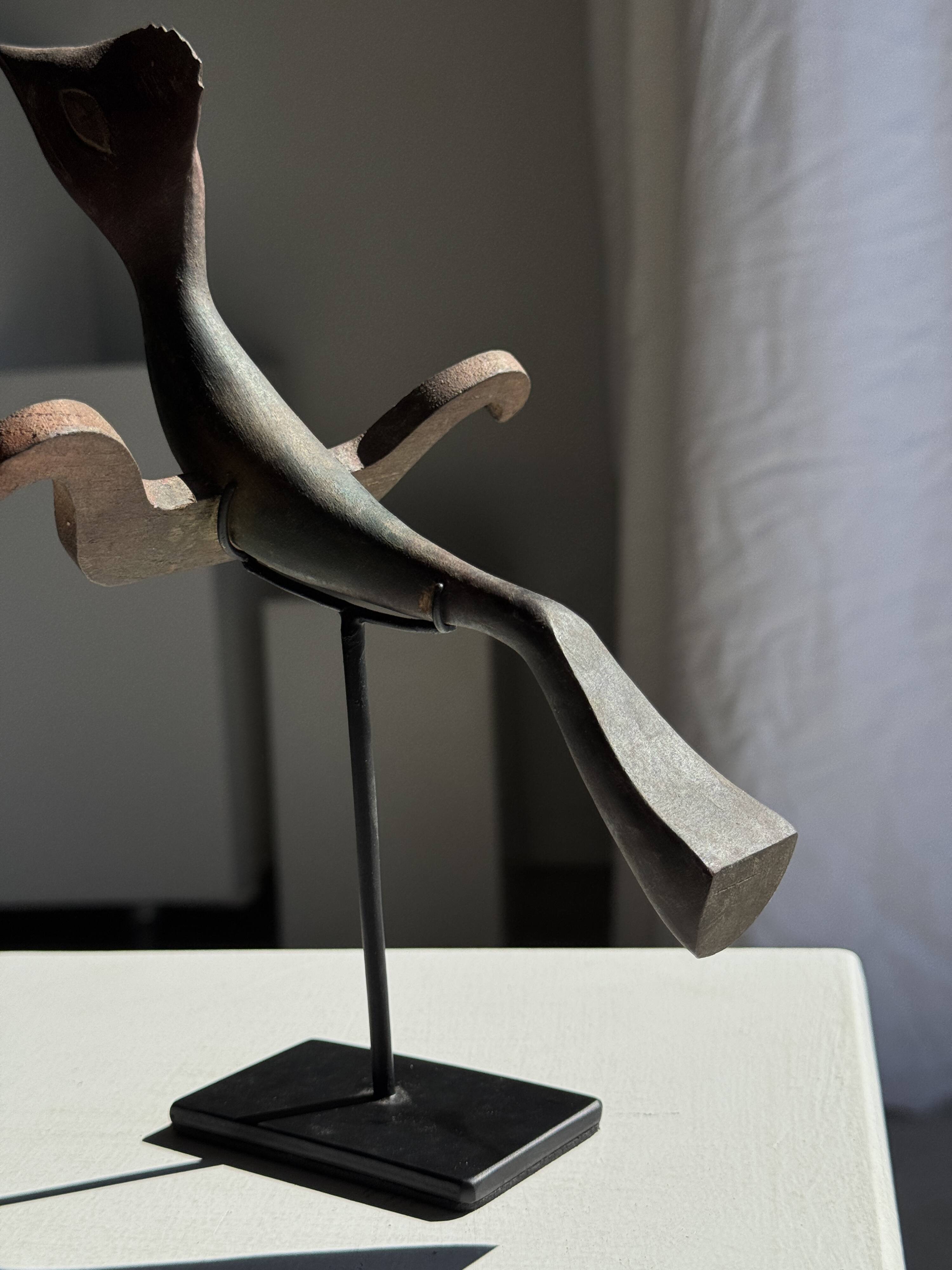 Traditional Indonesian decorative wooden bird on a base, crest model.