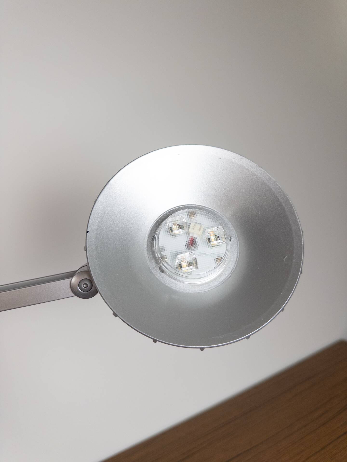 Grey LED architect lamp with spring arm and swivel base.