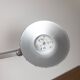 Grey LED architect lamp with spring arm and swivel base.