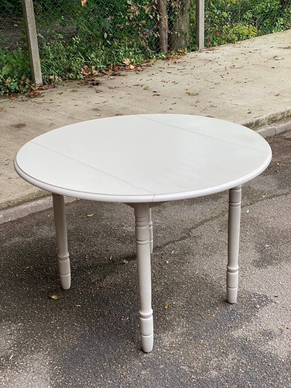 Louis Philippe round dining table with folding shutters repainted in beige grey