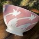 Old footed bowl in earthenware with pink decoration and defects.